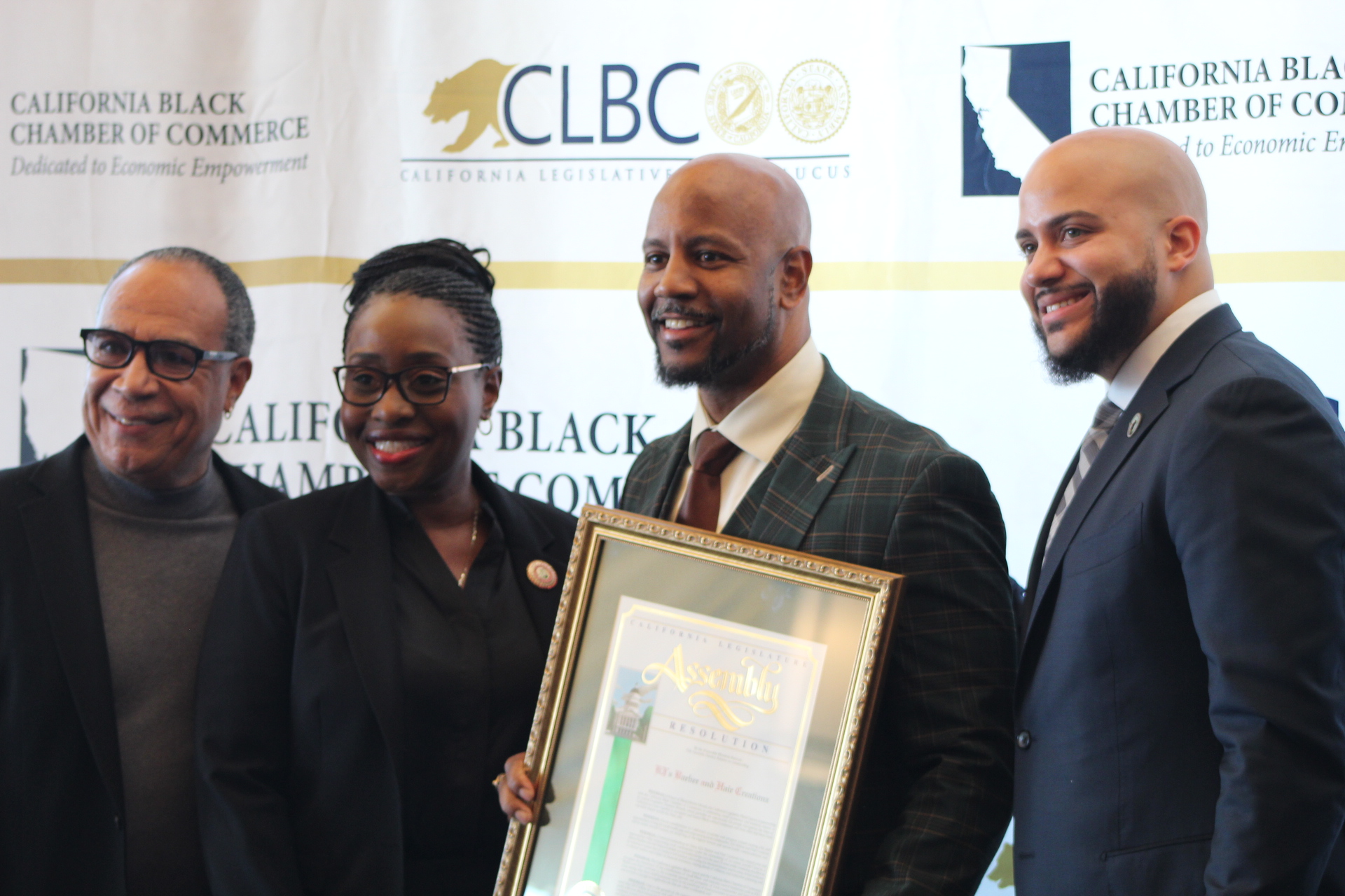 Assemblymember Ransom and KJ's Barbershop owner, Joseph Cannon pose with CEO of the California Black Chamber, Jay King, and Vice Chair of the California Legislative Black Caucus, Issac Bryan