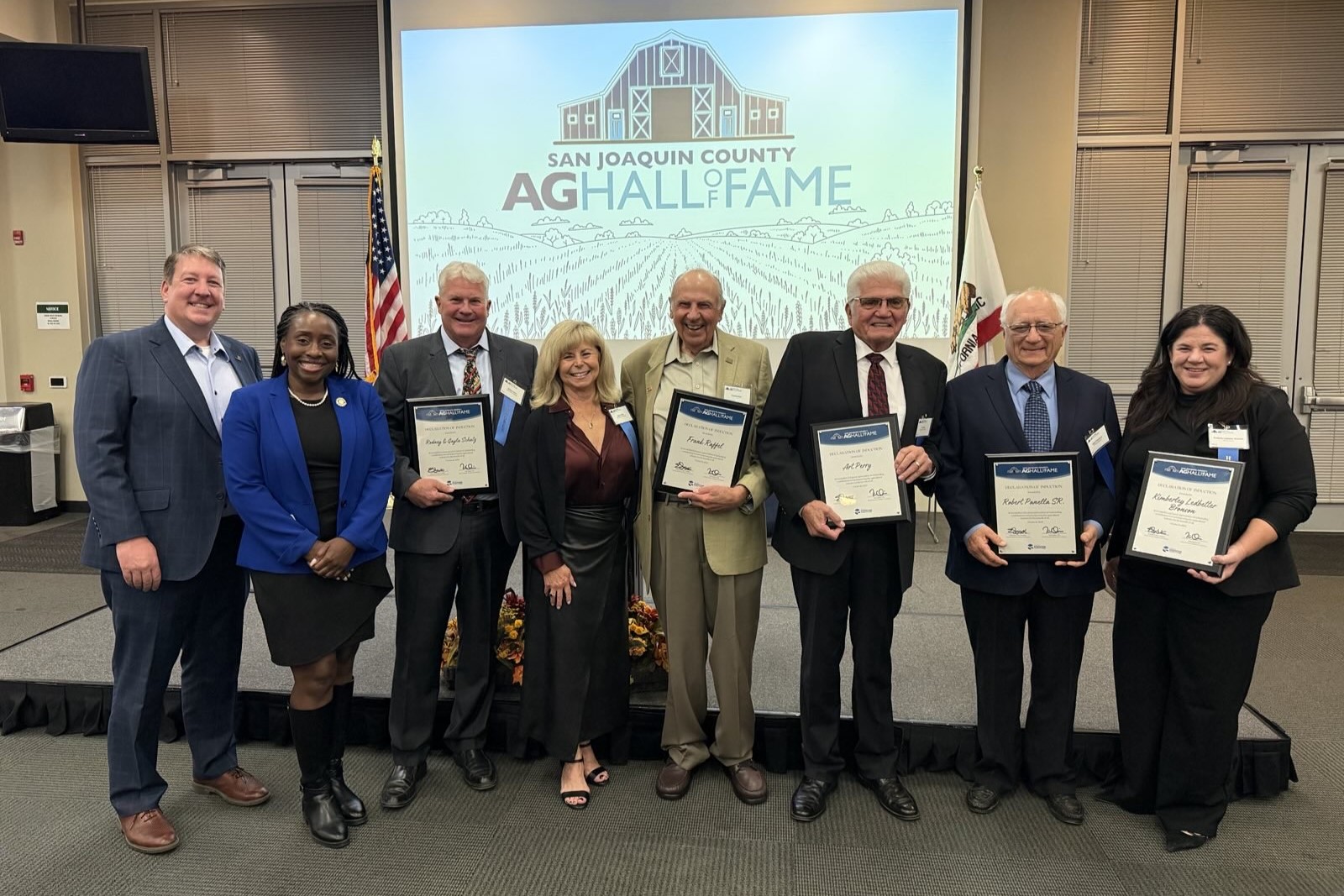 Inductees of the San Joaquin County Agricultural Hall of Fame take a picture with Assemblymember Rhodesia Ransom.