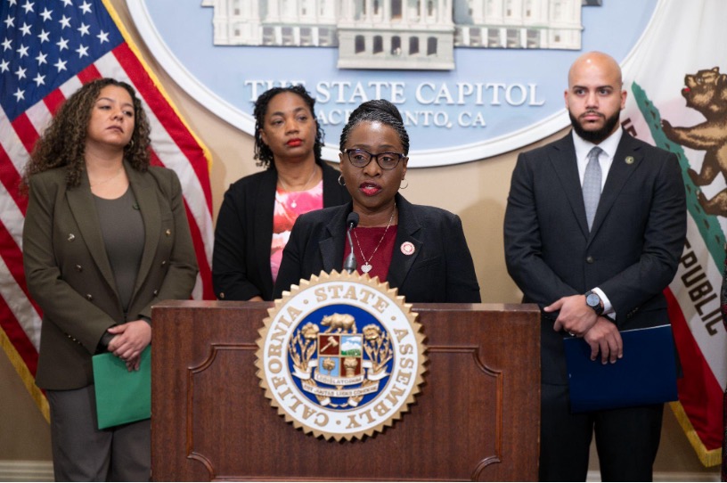 Assemblymember Rhodesia Ransom presenting remarks behind the podium.
