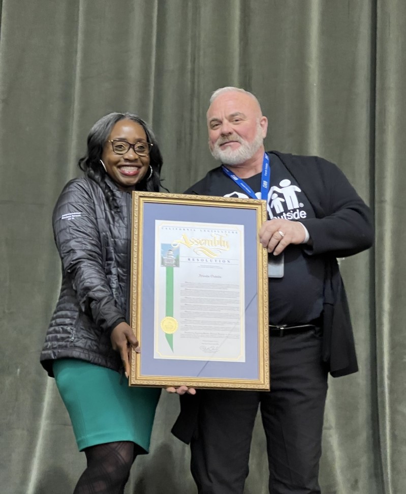 Assemblymember Rhodesia Ransom presenting a resolution to Executive Director of Friends Outside, Stockton