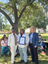 Assemblymember, Rhodesia Ransom, and Stanislaus State President, Britt Rios-Ellis, with graduating student