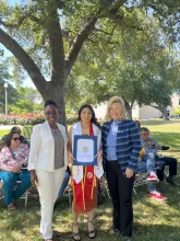 Assemblymember Rhodesia Ransom, and Stanislaus State President, Britt Rios-Ellis, with graduating student