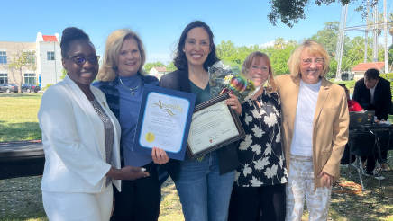 Assemblymember Rhodesia Ransom, and Stanislaus State President, Britt Rios-Ellis, with graduating student