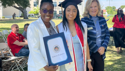 Assemblymember Rhodesia Ransom, and Stanislaus State President, Britt Rios-Ellis, with graduating student