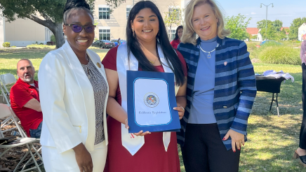 Assemblymember Rhodesia Ransom, and Stanislaus State President, Britt Rios-Ellis, with graduating student