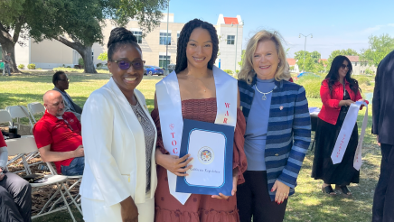 Assemblymember Rhodesia Ransom, and Stanislaus State President, Britt Rios-Ellis, with graduating student