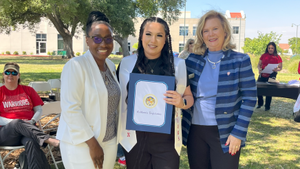 Assemblymember Rhodesia Ransom, and Stanislaus State President, Britt Rios-Ellis, with graduating student