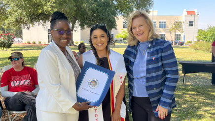 Assemblymember Rhodesia Ransom, and Stanislaus State President, Britt Rios-Ellis, with graduating student