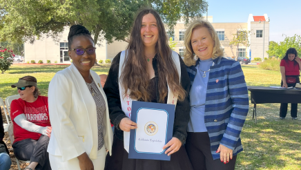 Assemblymember Rhodesia Ransom, and Stanislaus State President, Britt Rios-Ellis, with graduating student