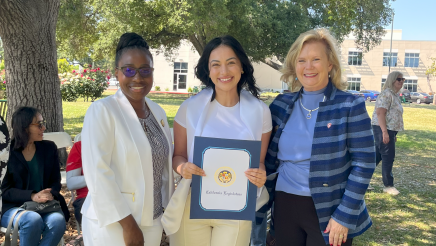Assemblymember Rhodesia Ransom, and Stanislaus State President, Britt Rios-Ellis, with graduating student