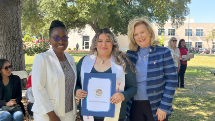 Assemblymember Rhodesia Ransom, and Stanislaus State President, Britt Rios-Ellis, with graduating student