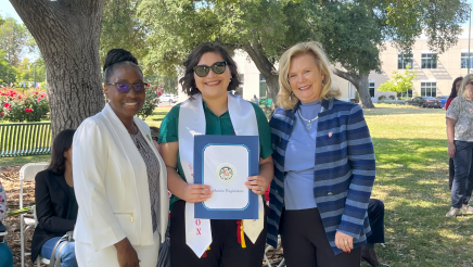 Assemblymember Rhodesia Ransom, and Stanislaus State President, Britt Rios-Ellis, with graduating student