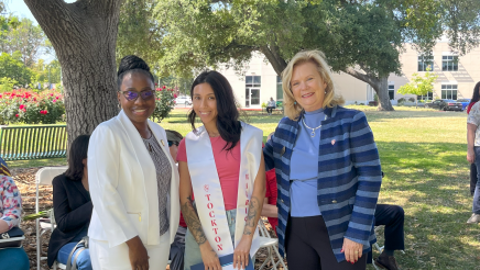 Assemblymember Rhodesia Ransom, and Stanislaus State President, Britt Rios-Ellis, with graduating student