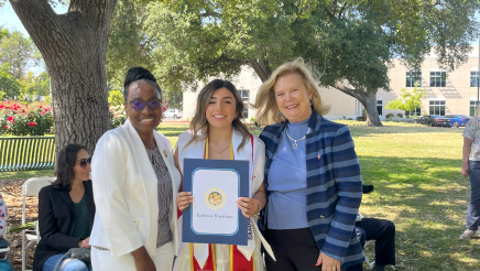 Assemblymember Rhodesia Ransom, and Stanislaus State President, Britt Rios-Ellis, with graduating student