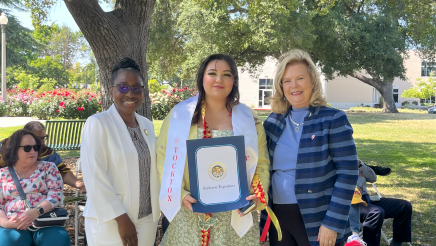 Assemblymember, Rhodesia Ransom, and Stanislaus State President, Britt Rios-Ellis, with graduating student