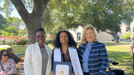 Assemblymember, Rhodesia Ransom, and Stanislaus State President, Britt Rios-Ellis, with graduating student