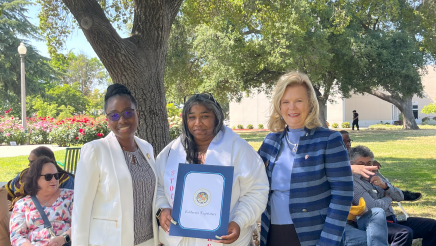 Assemblymember, Rhodesia Ransom, and Stanislaus State President, Britt Rios-Ellis, with graduating student