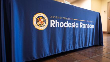 Table drape with Assemblymember Rhodesia Ransom’s name and logo at District 13 Open House in Stockton, CA 