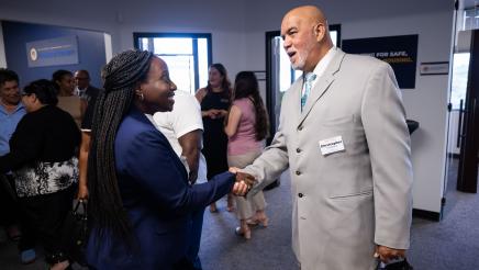 Community member meeting with Assemblymember Rhodesia Ransom during Open House